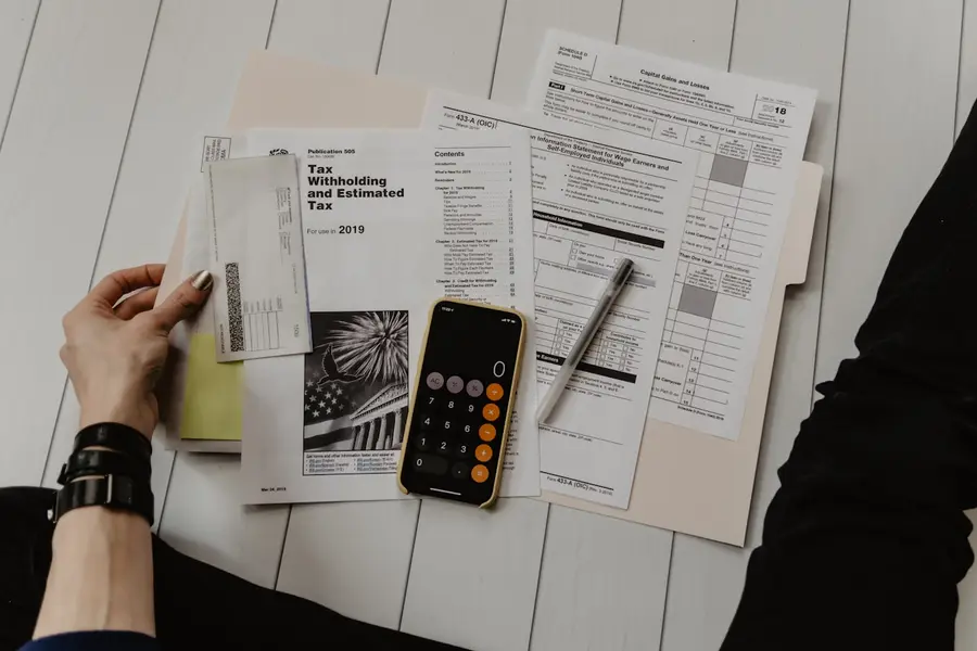 Paperwork, invoices and a calculator — the manual process Distribook replaces