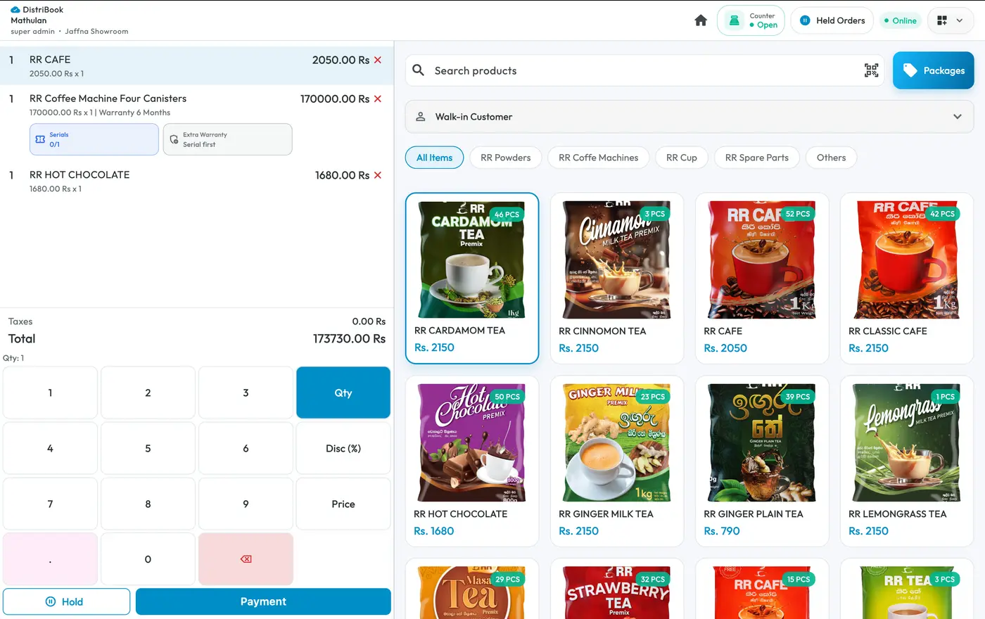 Distribook POS system running at a Jaffna showroom, showing a live sale with serial numbers, warranty, held orders and a searchable product grid